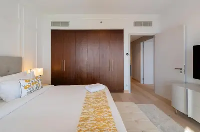 a bedroom with a large bed and a television at EDEN'S Homes & Villas - Boulevard Point in Dubai