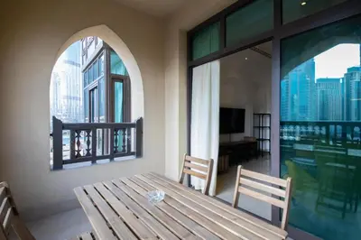 a room with a wooden table and a window at Chic 2BR with Burj Khalifa View in Souk Al Bahar in Dubai