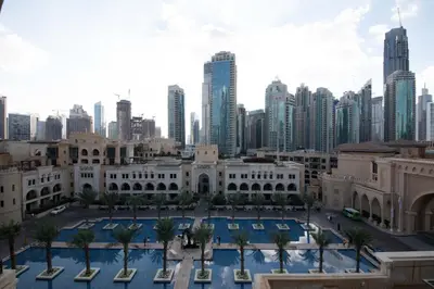 a view of the city of dubai from the palace of parliament at Chic 2BR with Burj Khalifa View in Souk Al Bahar in Dubai