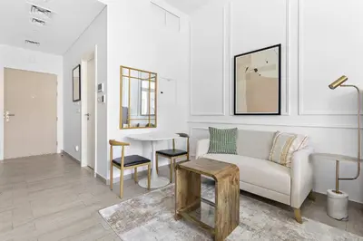 a living room with a couch and a table at Silkhaus Modern Studio In a Quiet Neighborhood in Dubai