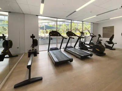 a gym with several tread machines in a room at Silkhaus Modern Studio In a Quiet Neighborhood in Dubai