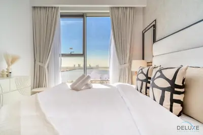 a bedroom with a white bed with a large window at Captivating 1BR at 17 Icon Bay Dubai Creek Harbour by Deluxe Holiday Homes in Dubai