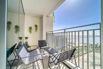 a balcony with chairs and a view of the ocean at Captivating 1BR at 17 Icon Bay Dubai Creek Harbour by Deluxe Holiday Homes in Dubai