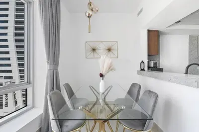 a dining room with a glass table and chairs at StoneTree - Park Island Blakely 1 BR - Prime location in Dubai