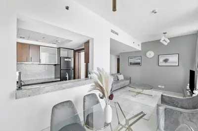 a kitchen and living room with a table and chairs at StoneTree - Park Island Blakely 1 BR - Prime location in Dubai