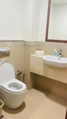 a bathroom with a toilet and a sink at AMAKIN Burj Vista Tower 1 in Dubai
