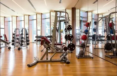 a gym with a lot of treadms and machines at AMAKIN Burj Vista Tower 1 in Dubai