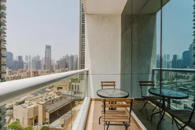 a balcony with chairs and a view of a city at RH- City Center Retreat,1BR, walk to Burj Khalifa in Dubai