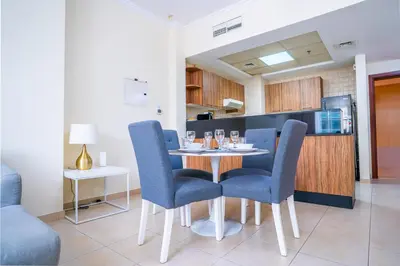 a dining room with a table and blue chairs at RH- City Center Retreat,1BR, walk to Burj Khalifa in Dubai