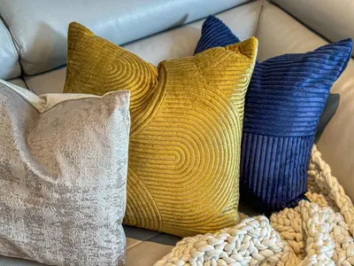 a grouping of pillows on a couch at HiGuests - Charming Retreat in CityWalk With Balcony and Pool in Dubai