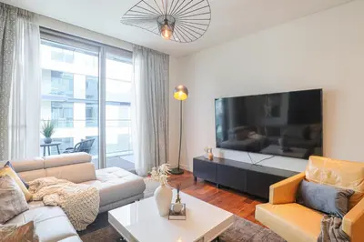 a living room with a large flat screen tv at HiGuests - Charming Retreat in CityWalk With Balcony and Pool in Dubai