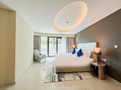 a bedroom with a large white bed and a large window at Luton Vacation Homes - Damac Tower By Paramount - Business Bay, Dubai - 80AB4 in Dubai