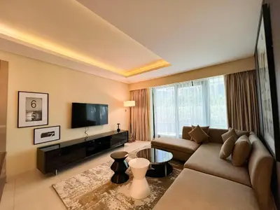 a living room with a couch and a flat screen tv at Luton Vacation Homes - Damac Tower By Paramount - Business Bay, Dubai - 80AB4 in Dubai