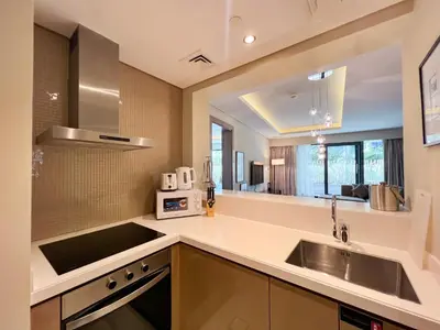 a kitchen with a sink and a large mirror at Luton Vacation Homes - Damac Tower By Paramount - Business Bay, Dubai - 80AB4 in Dubai