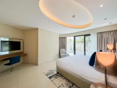a bedroom with a large bed and a flat screen tv at Luton Vacation Homes - Damac Tower By Paramount - Business Bay, Dubai - 80AB4 in Dubai