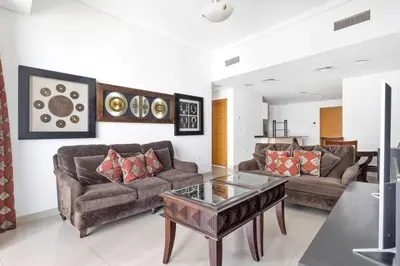 a living room with two couches and a coffee table at StoneTree - Ocean Heights 1 BR - High Floor in Dubai