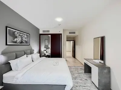 a bedroom with a large white bed in a room at StoneTree - Elite Residence 1 BR - Near Dubai Tram in Dubai