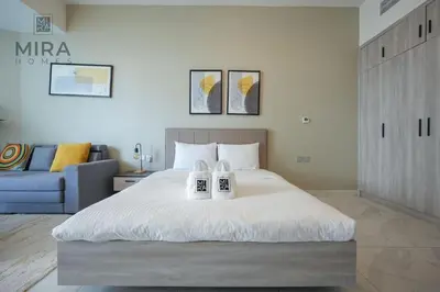 a bedroom with a large bed with two candles on it at Mira Holiday Homes - Fully furnished Studio in Business Bay in Dubai