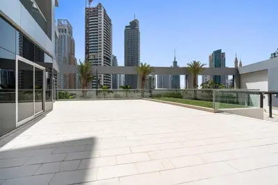 a patio in a building with a city in the background at StoneTree - SkyView Tower 1 BR - Best Location in Dubai