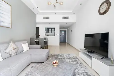 a living room with a couch and a table at StoneTree - SkyView Tower 1 BR - Best Location in Dubai