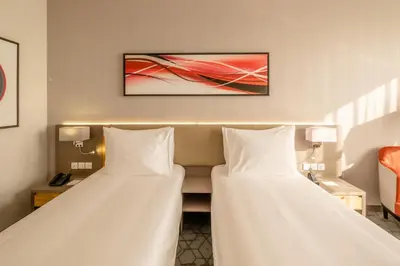 two beds sitting next to each other in a hotel room at Peony Hotel in Dubai