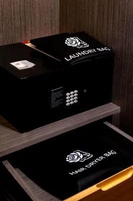 a box sitting on top of a wooden shelf at Peony Hotel in Dubai