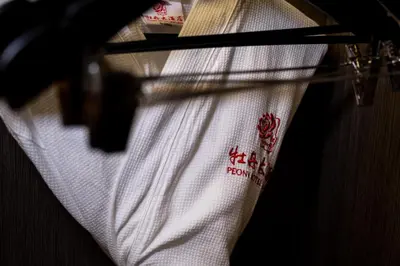 a white shirt is hanging on a rack at Peony Hotel in Dubai