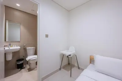 a bathroom with a sink toilet and a mirror at Sea View with Private Beach Access! 3BR & Maid Rm in Dubai