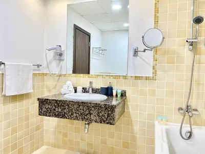 a bathroom with a sink and a mirror at JBR Beach - Panoramic Sea View 2BR Apartment in Dubai
