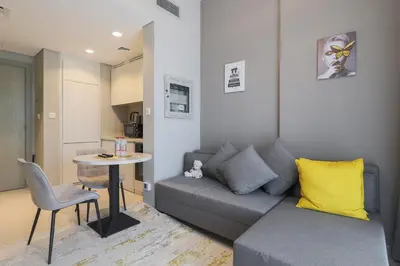 a living room with a couch and a table at Business Bay 1 bedroom with Canal view in Dubai