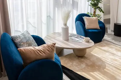 a living room with two blue chairs and a table at Luxury Residence Stella Maris in Dubai