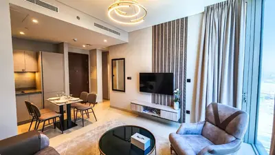 a living room with a couch and a table at STAY BY LATINEM Luxury 1BR Holiday Home CVR A3001 near Burj Khalifa in Dubai