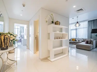 a living room with a white shelf in the middle at Charming 2Br in Boulevard Crescent - Downtown Dubai in Dubai