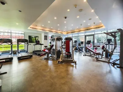 a gym with several treadmills and machines in a room at Charming 2Br in Boulevard Crescent - Downtown Dubai in Dubai
