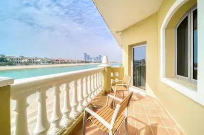 a balcony with chairs and a view of the ocean at Frond E Villa, Palm Jumeirah - Mint Stay in Dubai