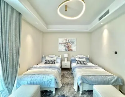 a room with three beds and a window at Sea View Apartments Marina with Party Hall in Dubai