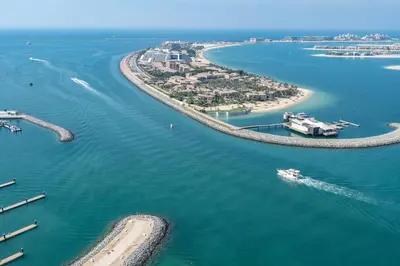 an aerial view of a beach with a boat in the water at Vogue Emaar Beachfront Beach Vista near JBR and Palm Jumeirah, One Bedroom Apartment with Balcony and Private Beach, Access to all Amenities in Dubai