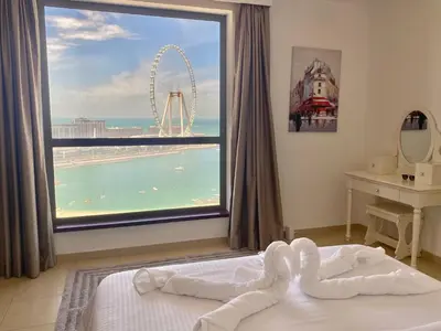 a bedroom with a large window with a view of the roller coaster at JBR Sea View 2 Bedroom Apartment in Dubai