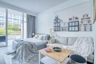 a living room with a couch and a bed and a table at The Smart Concierge - Luma 21 in Dubai