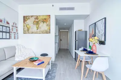 a living room with a couch and a table at The Smart Concierge - Luma 21 in Dubai