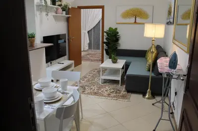 a living room with a couch and a table at Newly furnished cozy 1 bedroom apartment close to JBR beach and metro in Dubai