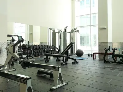 a gym with a lot of treadmills and machines at Frank Porter - Burj Views Tower A in Dubai