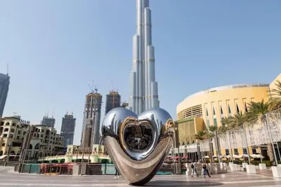 a heart sculpture in the middle of a city at Frank Porter - Burj Views Tower A in Dubai