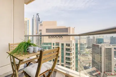 a balcony with a bench and a view of a city at Frank Porter - Burj Views Tower A in Dubai