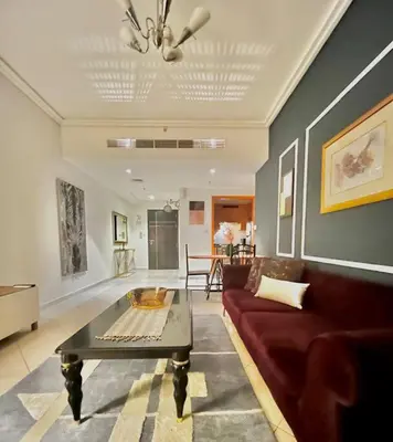 a living room with a couch and a coffee table at Chic 3 bedroom apartment in Dubai