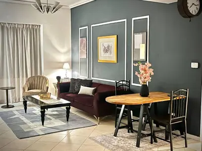 a living room with a couch and a table at Chic 3 bedroom apartment in Dubai