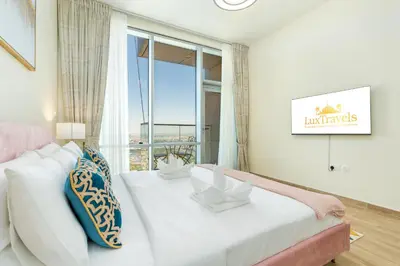 a living room with a white couch and a large window at Lux BnB I Amna Tower I Panaromic Views in Dubai
