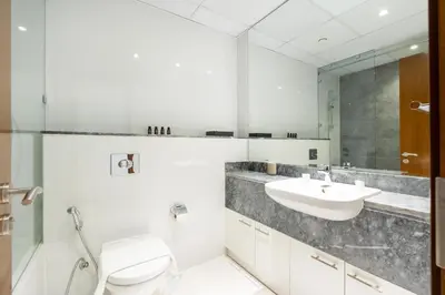 a bathroom with a toilet and a sink at Lux BnB I Amna Tower I Panaromic Views in Dubai