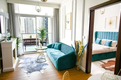 a living room with a couch and a bed at Vera Residence with Canal View in Dubai