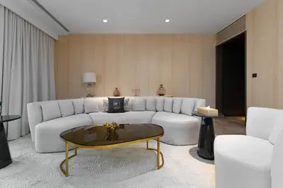 a living room with a white couch and a coffee table at Maison Privee - Glamourous Apt with Sea Views at FIVE Palm in Dubai